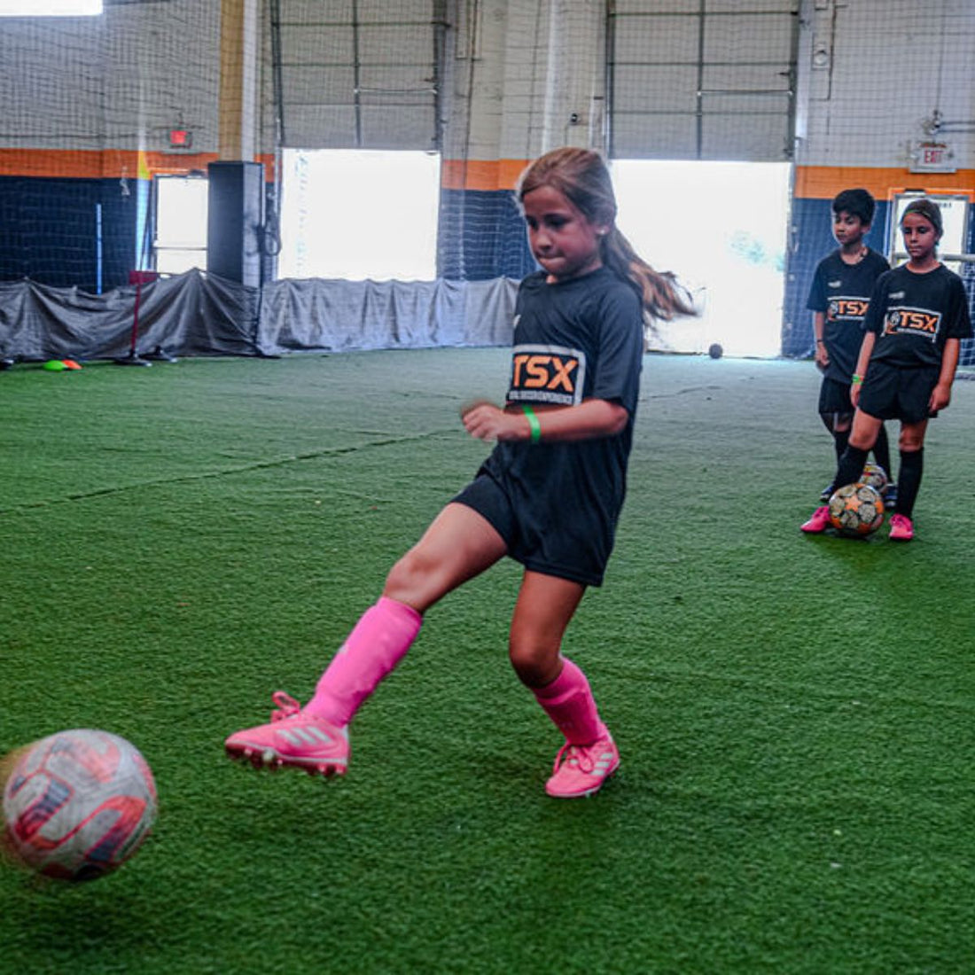 Total Soccer kid playing soccer indoors with &