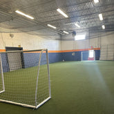 Total Soccer Indoor sports facility with soccer goal and artificial turf
