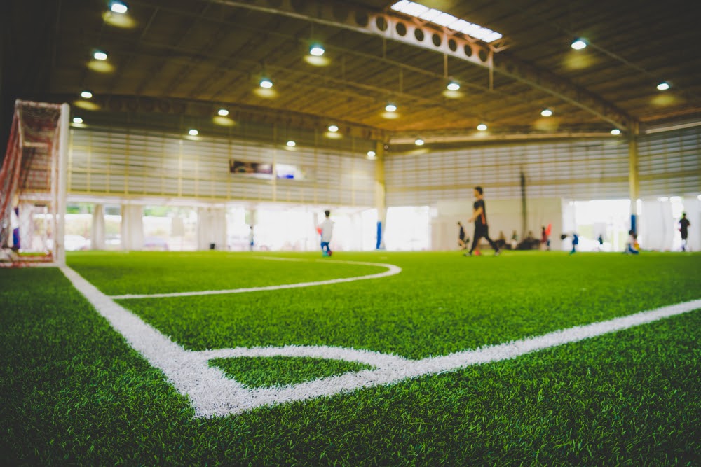 Corner Line of an indoor football soccer training field in Junior Soccer Academy school with blurred children and coach practicing on the background