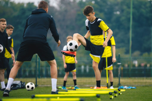 teens training for soccer outdoors